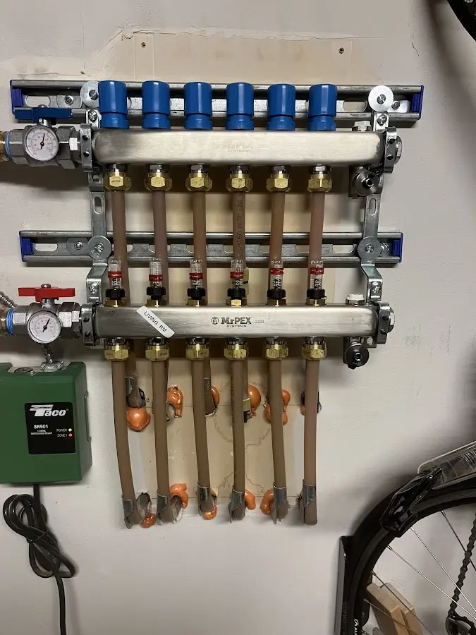 Plumber performing Water Heater Repair at a residential property in Elkins